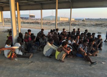 Rescued migrants sit on a coast (Hazem Ahmed/AP)