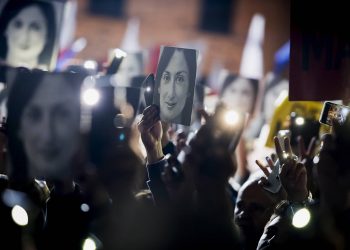 People hold pictures of slain journalist Daphne Caruana Galizia as they protest outside the office of the Maltese Prime Minister Joseph Muscat, calling for the resignation of Muscat, in Valletta, Malta., Friday, Nov. 29, 2019. The family of the journalist who was killed by a car bomb in Malta is urging Muscat to resign, after his former chief aide was released from jail in a probe aimed at finding the mastermind of the 2017 murder. (AP Photo/Rene Rossignaud)