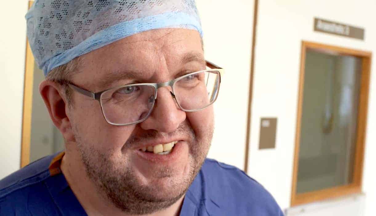 Amputation surgeon back at work after having both legs removed