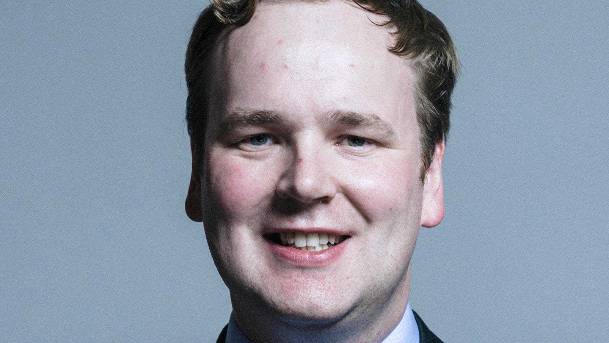 Tory MP backs call to scrap NHS fee for overseas carers