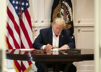 In this image released by the White House, President Donald Trump works in the Presidential Suite at Walter Reed National Military Medical Center in Bethesda, Md. Saturday, Oct. 3, 2020, after testing positive for COVID-19. (Joyce N. Boghosian/The White House via AP)