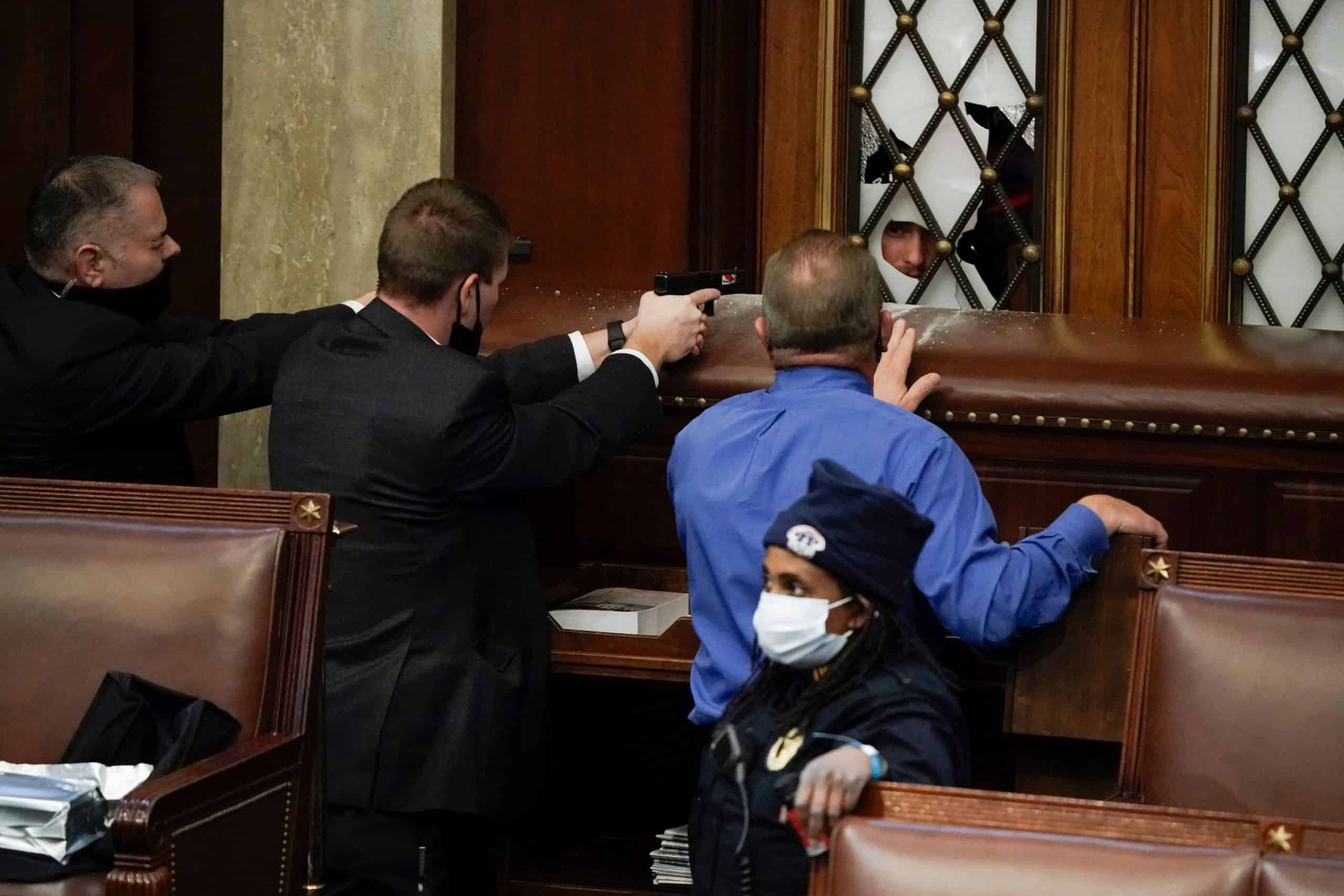 Watch – ‘Shots fired’ Armed stand off and members of Congress shelter as Trump supporters flood Capitol