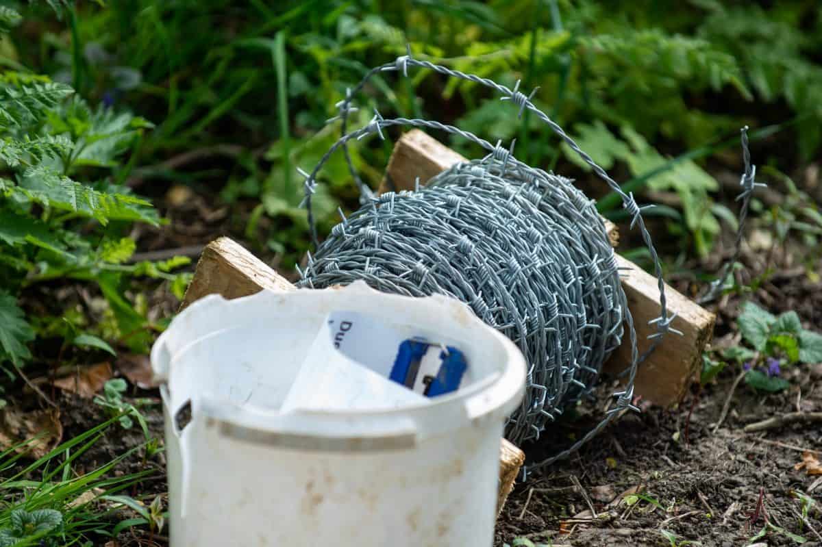 Razor-sharp barbed wire installed across footpath in row with ramblers