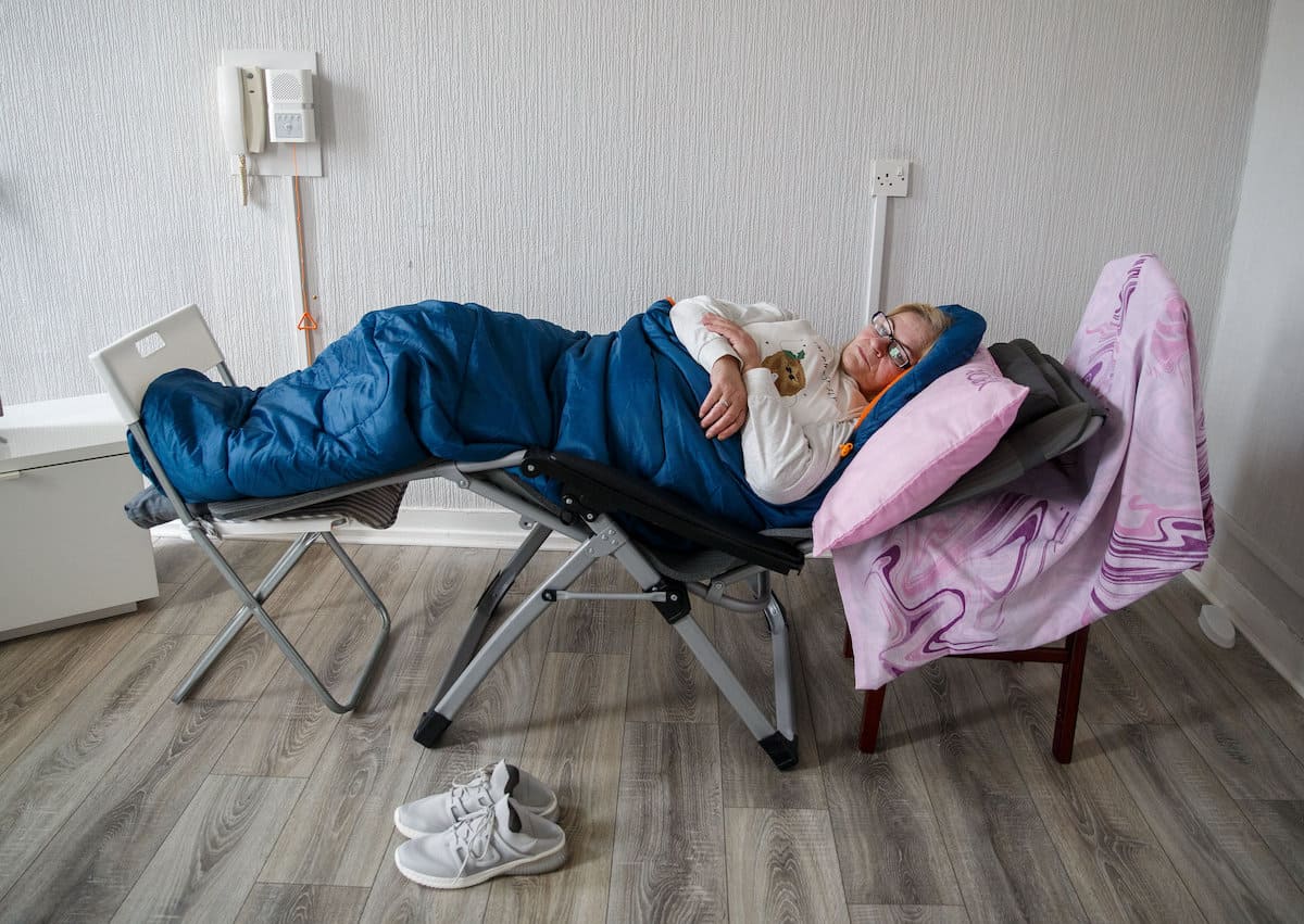 Disabled woman forced to sleep on 2 chairs pushed together due to unfurnished social housing