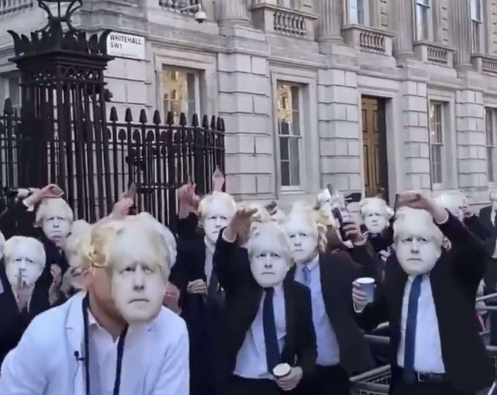 WATCH: Dozens wearing Boris masks and wigs gather outside Downing St