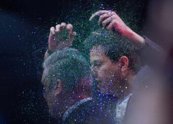 A protester throws glitter over and disrupts Labour leader Sir Keir Starmer making his keynote speech during the Labour Party Conference in Liverpool. Picture date: Tuesday October 10, 2023.