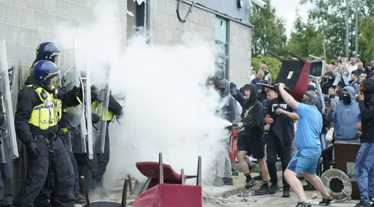 Ten police officers injured and one unconscious after rioters target migrant hotel